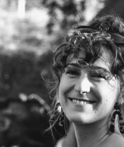 black and white photo of female smiling with curly hair