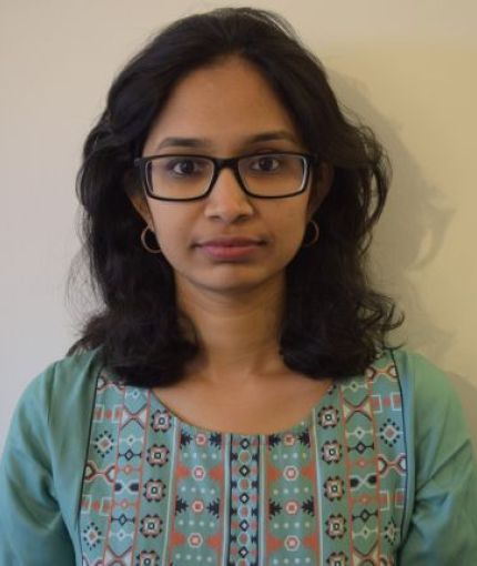 Picture of Srravya Chandhiramowuli which shows a woman of South Asian heritage, shoulder-length black hair, and wearing rectangular spectacles.