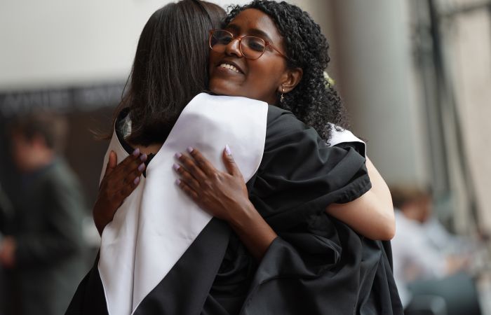 Two SPS graduates hugging