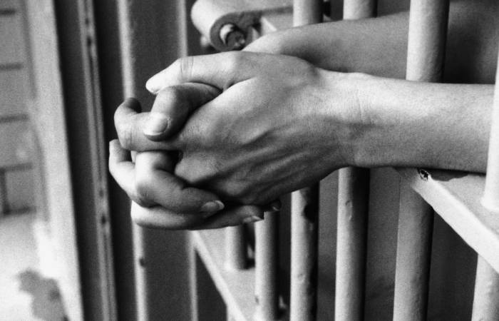 Hand in Prison Cell Social Work Law Seminar