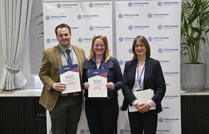 The Scottish Election Study team holding their prize certificates and smiling into the camera