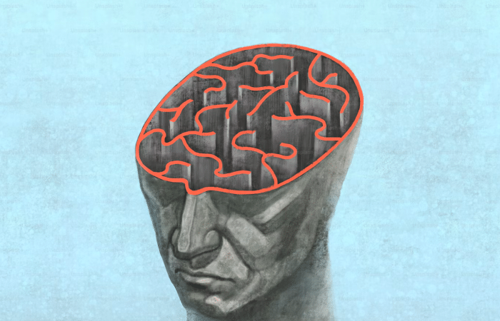 The image is a conceptual stock illustration by Jorm Sangsorn titled Brain Think Psychology Mind Maze Concept, depicting a human head with an open skull containing a red-lined labyrinth instead of a brain.