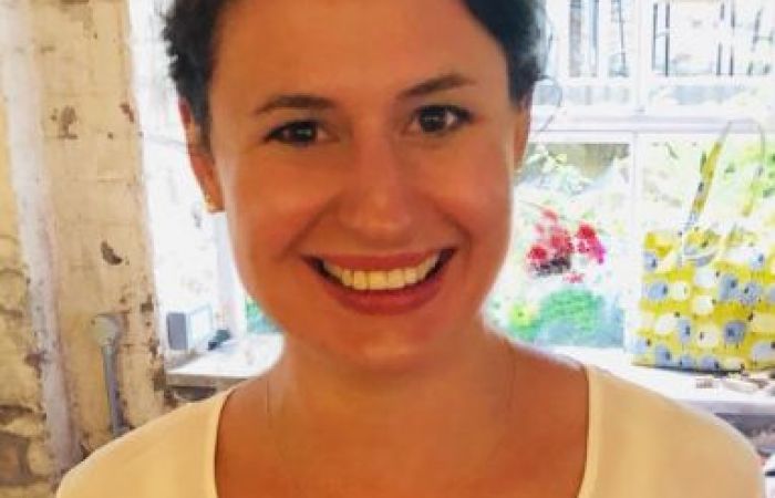 I am a white female with dark brown hair tied back and wearing a white shirt.