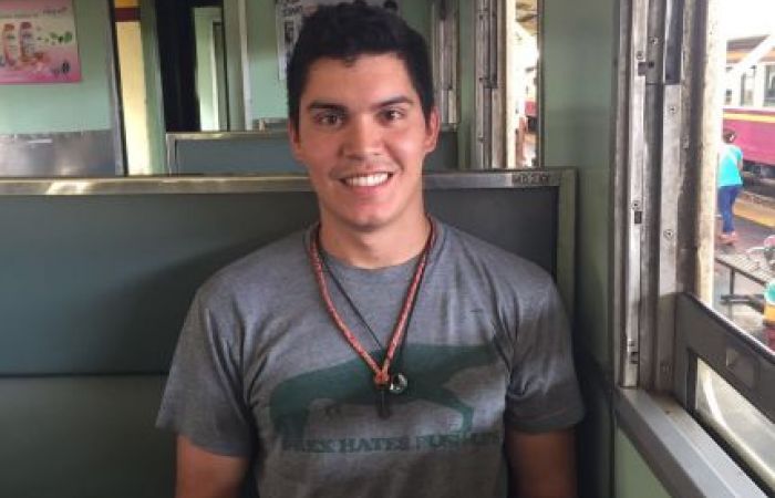 Ben Coulson sat on a train in Thailand