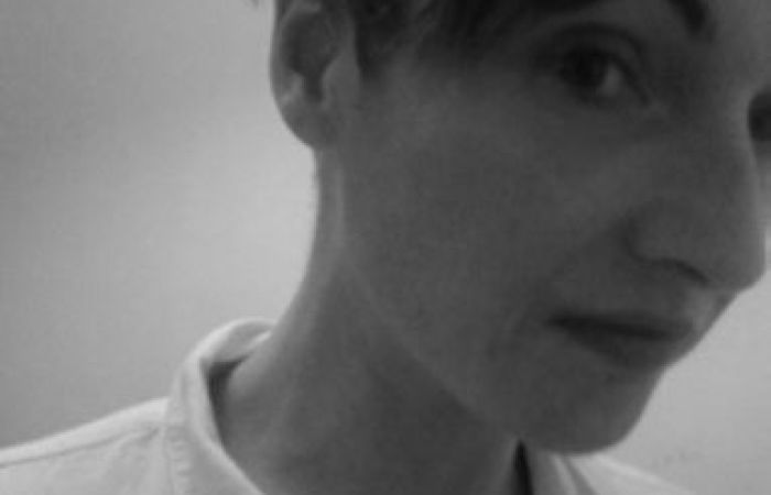 Black and white image of white woman wearing a white shirt.