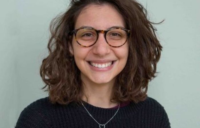 Image of a woman smiling in front of the camera