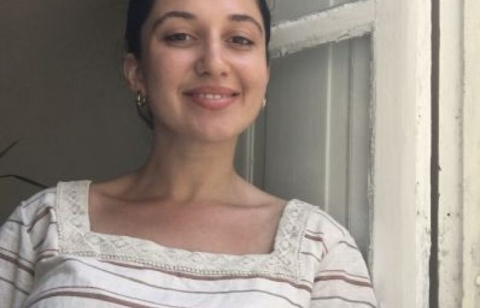 Picture of a woman in front of a window.