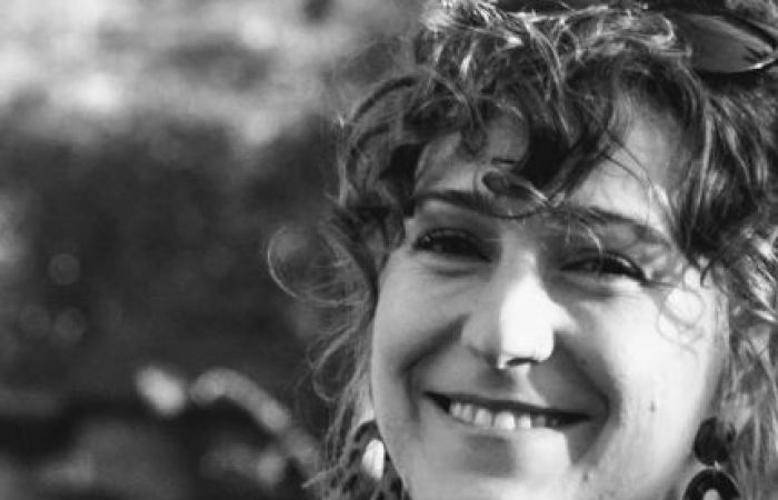 black and white photo of female smiling with curly hair