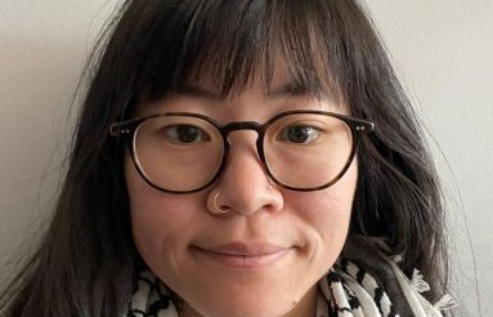 photo of a person with glasses wearing a kuffiyeh