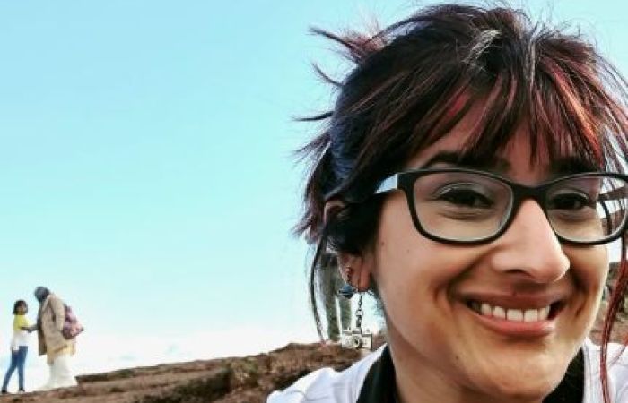 Aafiyah is smiling at the camera.