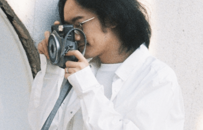A young man photographing his wife on their wedding day.