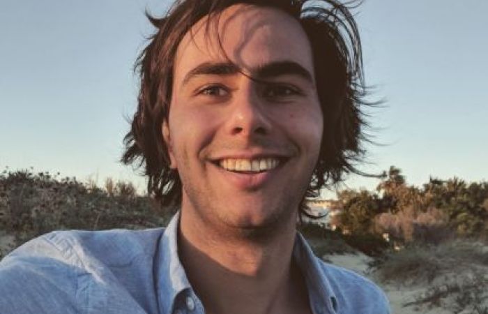 Picture of Soehail with a blue shirt on a white background smiling.